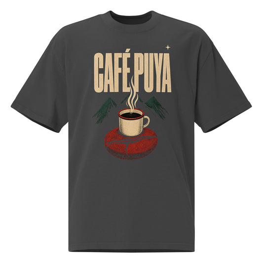 CAFÉ PUYA oversized faded black tee front - taza esmaltada humeando sobre grano de café rojo brick gigante, montañas verde petróleo de Yauco al fondo, texto wide bold crema CAFÉ PUYA, cartel revolucionario boricua PaisaRican