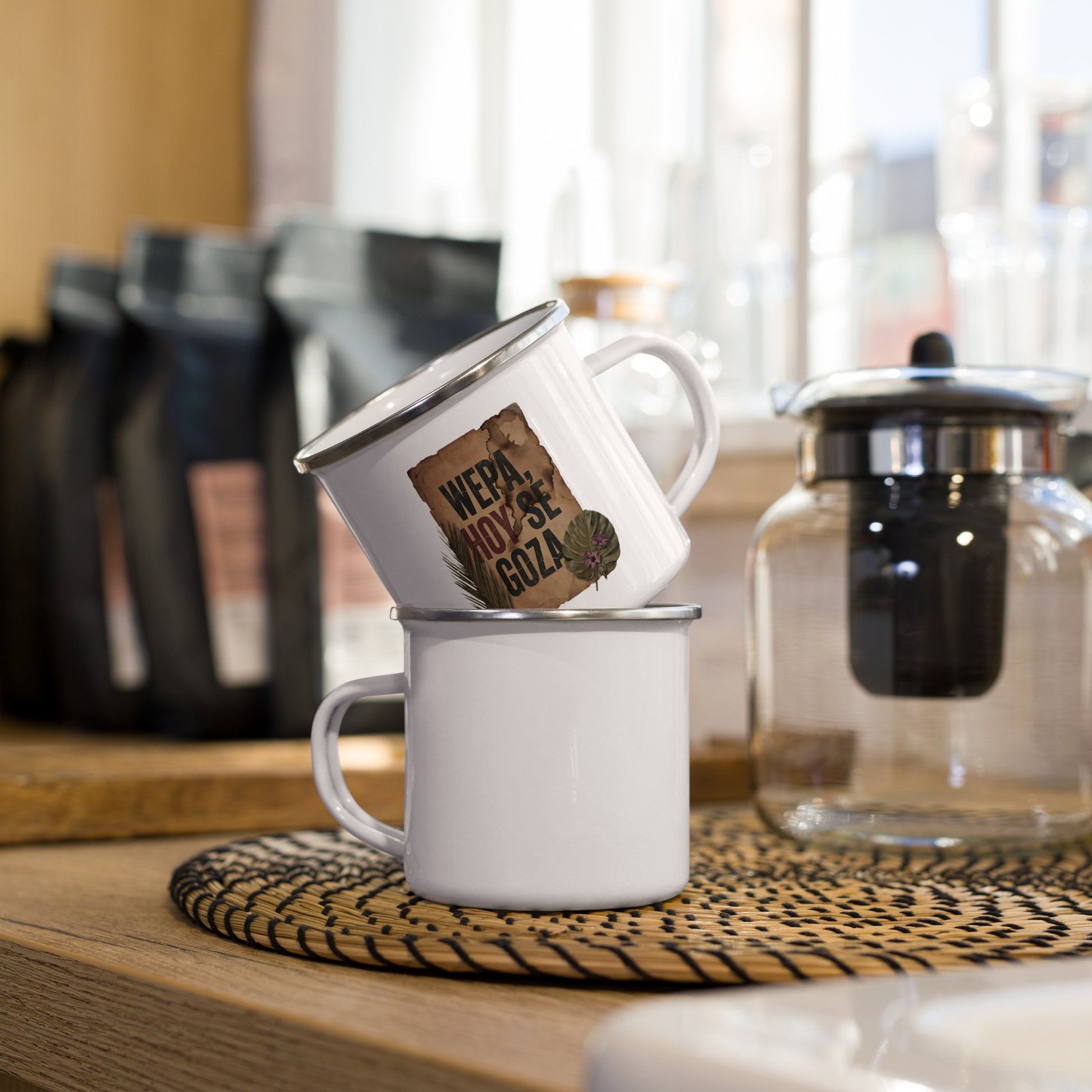 Dos tazas WEPA HOY SE GOZA Pergamino apiladas en cocina con bolsas de café y tetera — ambiente cafetería PaisaRican mug boricua